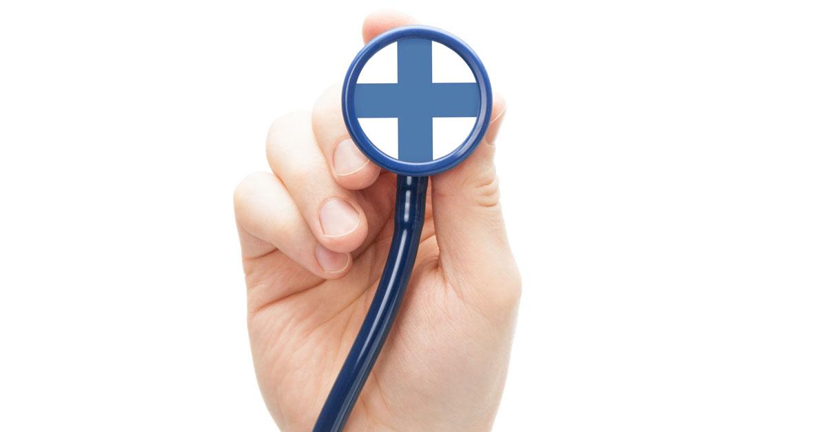 Hand holding stethoscope with Finnish flag on it